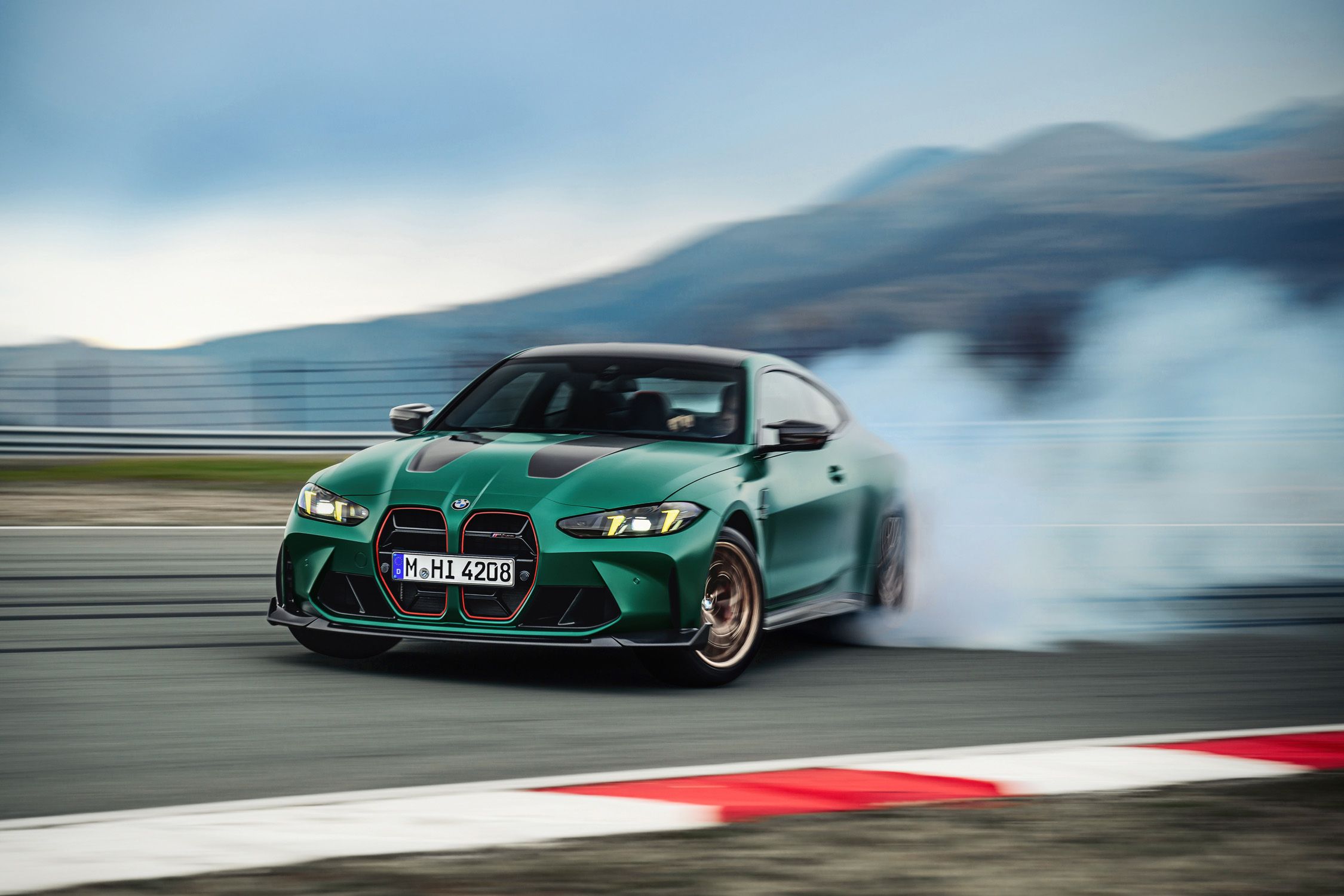 BMW M4 CS drifting on a racetrack, showcasing its aggressive front design, sharp handling, and track-focused performance