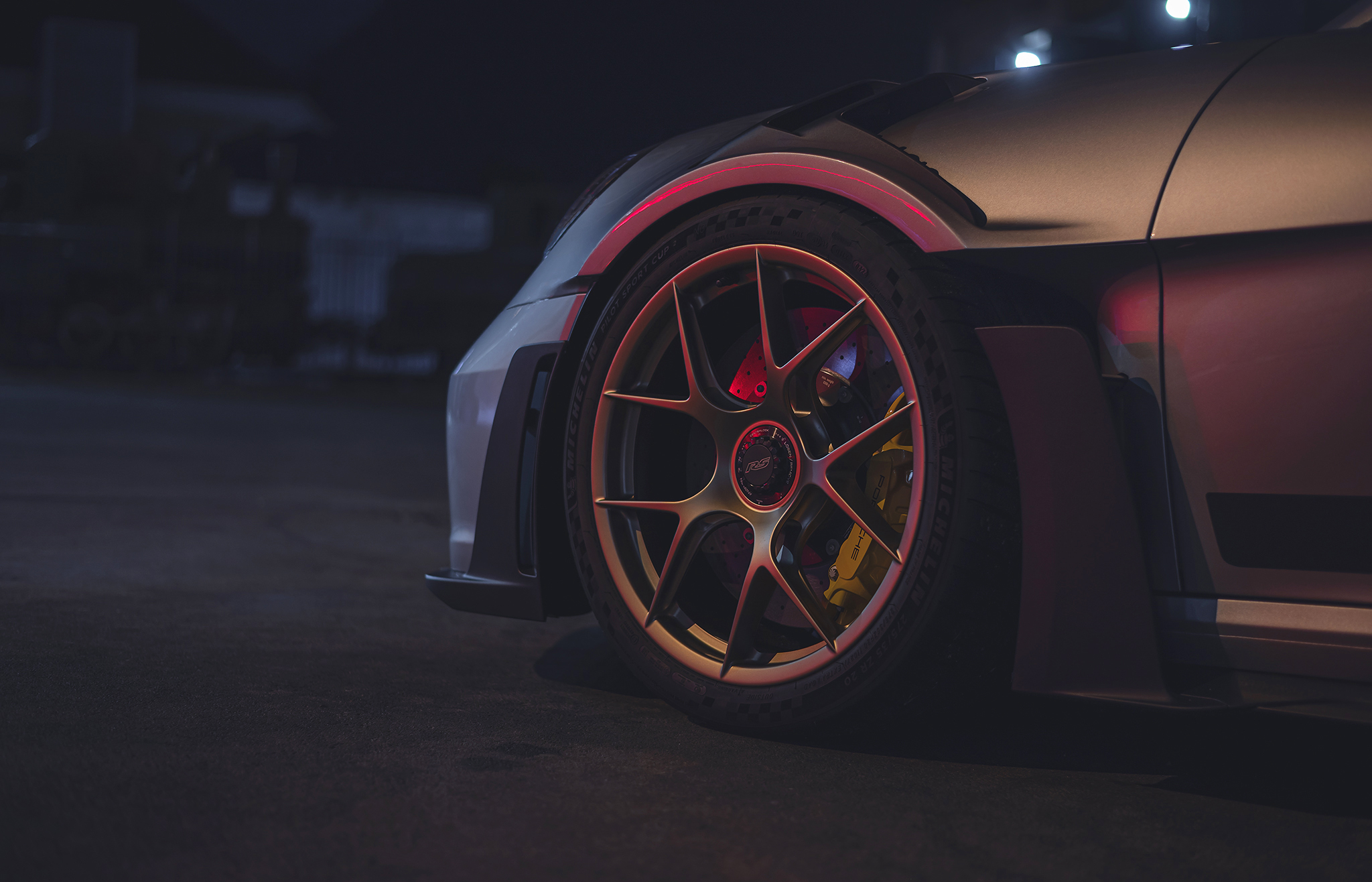 Porsche 911 GT3 RS front wheel and fender in night light