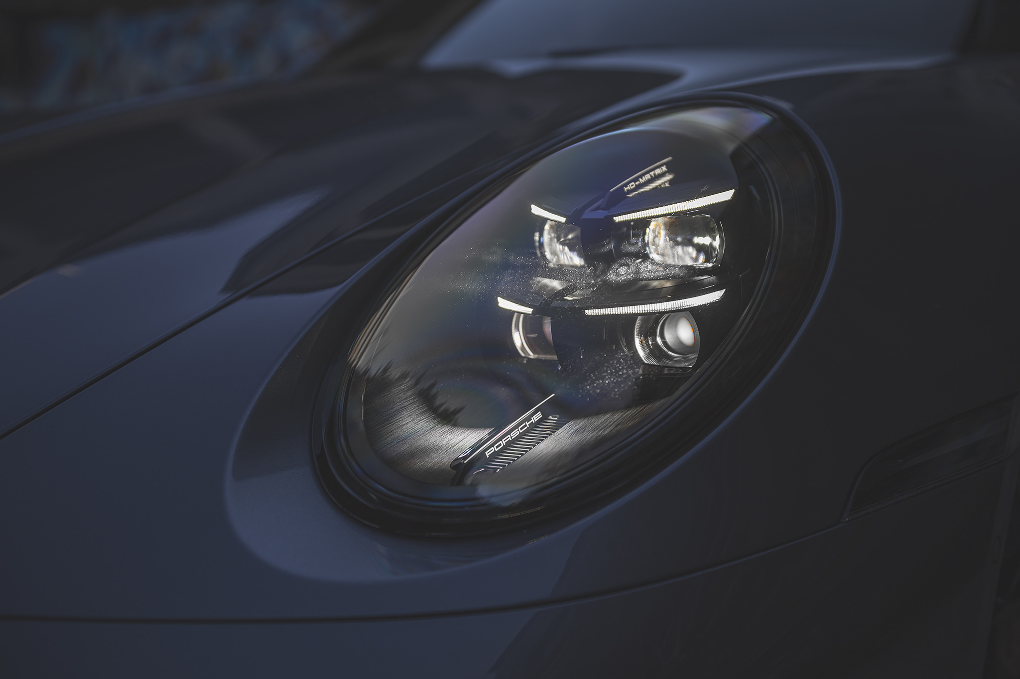 Close-up of Porsche 911 front headlight with LED matrix technology and signature design details