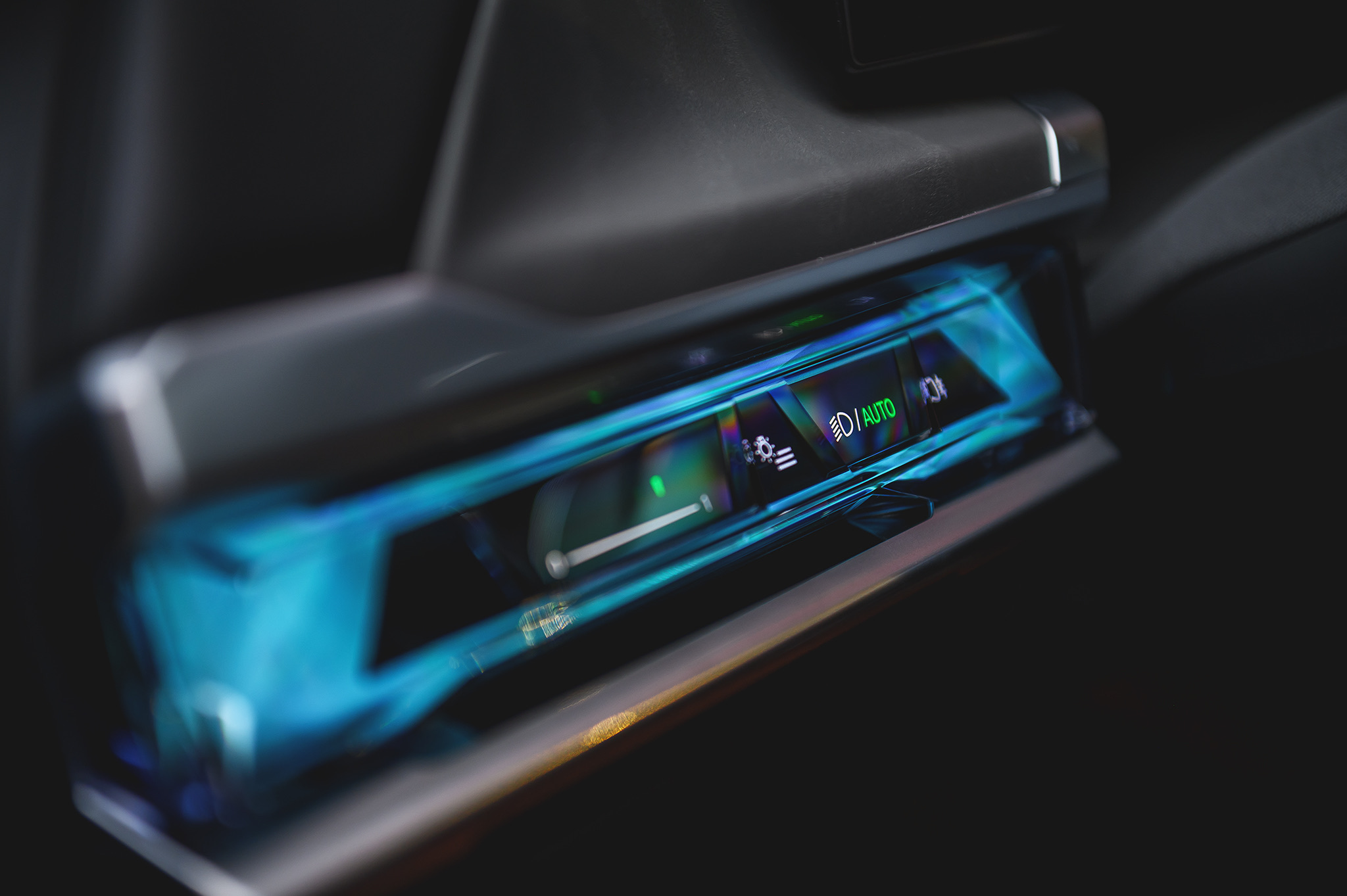 BMW 740d interior detail showing ambient lighting controls and advanced driver assistance settings in the luxury cabin